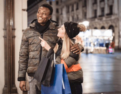 2024 holiday shopping | diverse couple holiday shoppig