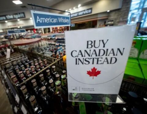 A sign is placed in front of the American whiskey section at a B.C. liquor store after top selling American made products have been removed from shelves in Vancouver, B.C.